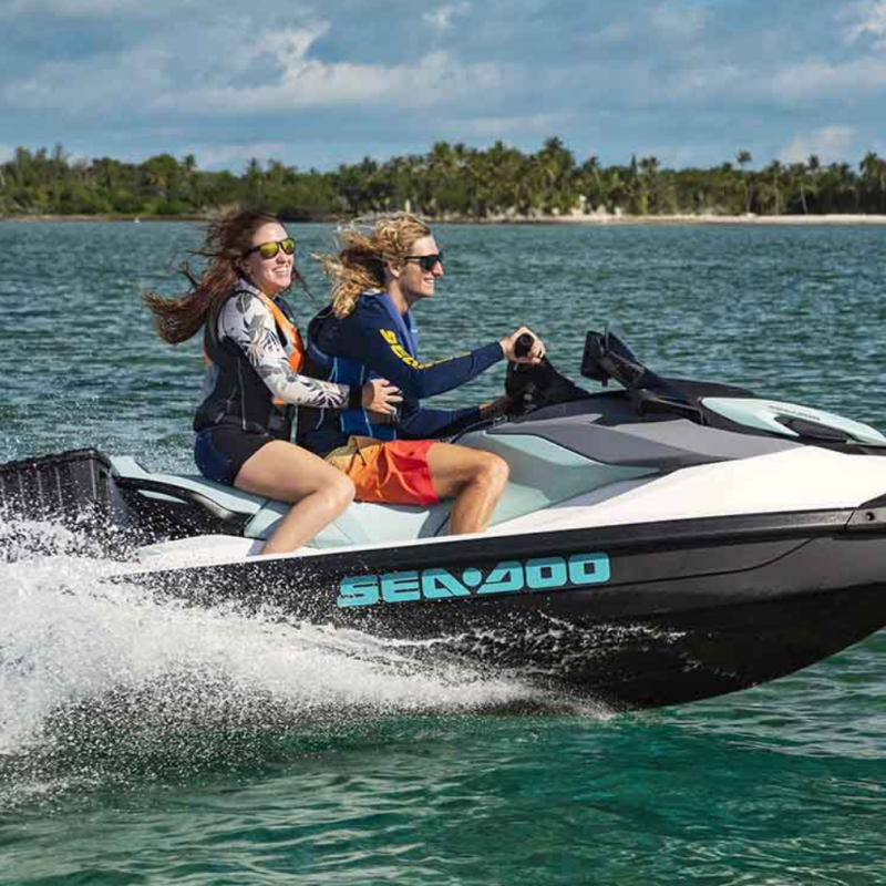 a person riding on the back of a boat in a body of water